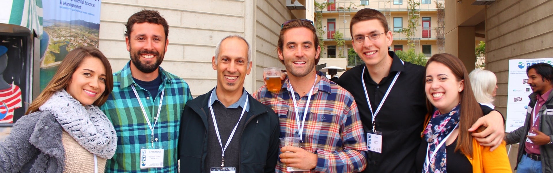 Six people link arm in arm smiling