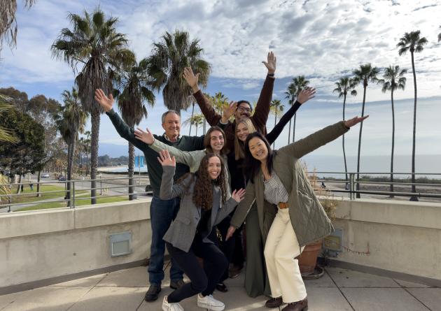 Master's group standing with arms out to mimic a palm tree